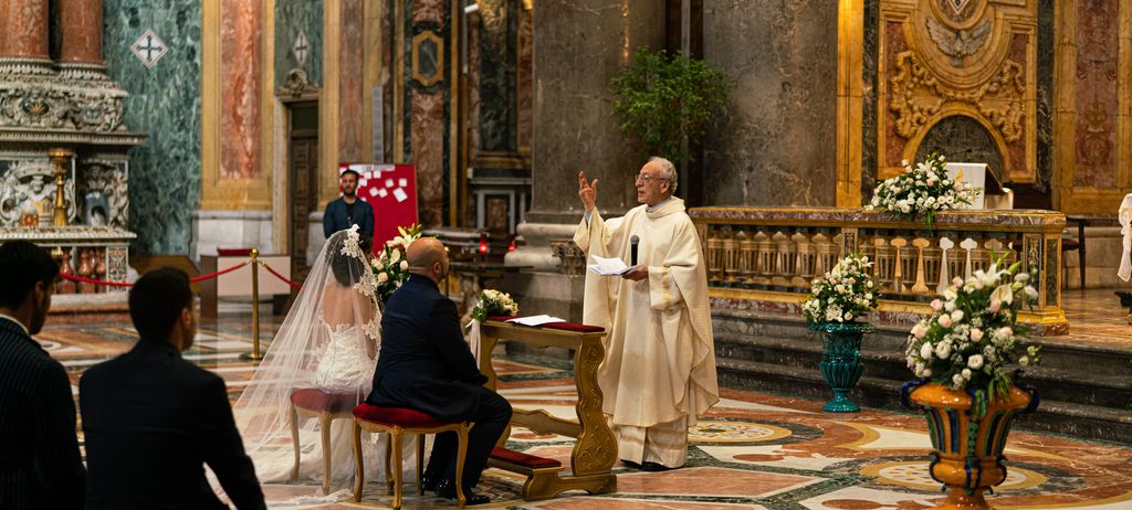 A wedding ceremony inside an ornately decorated church