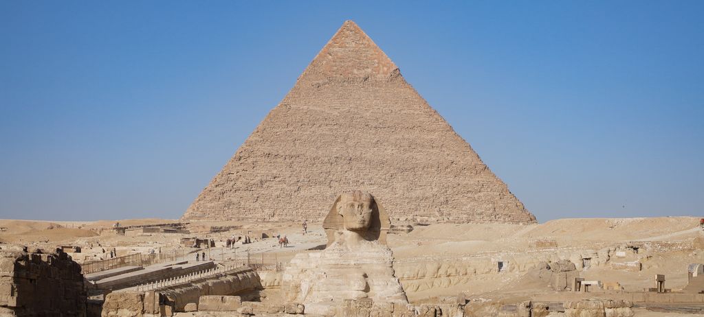 The Sphinx at Giza with the pyramid rising behind it