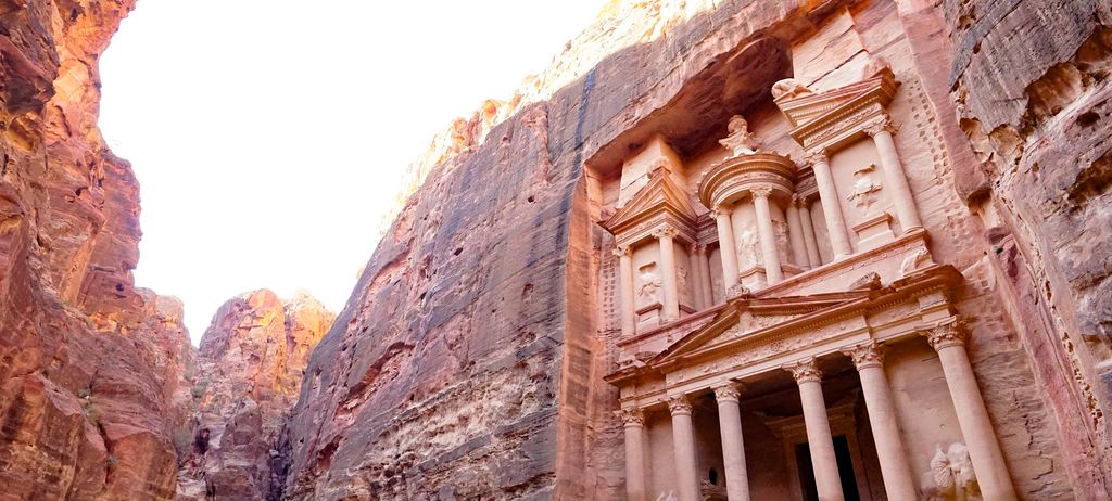 The Treasury of Petra carved into a canyon of rose-coloured rock