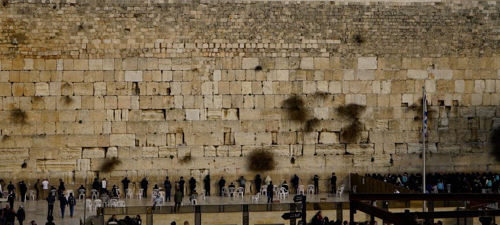 The Western Wall in Jerusalem with people gathered before it